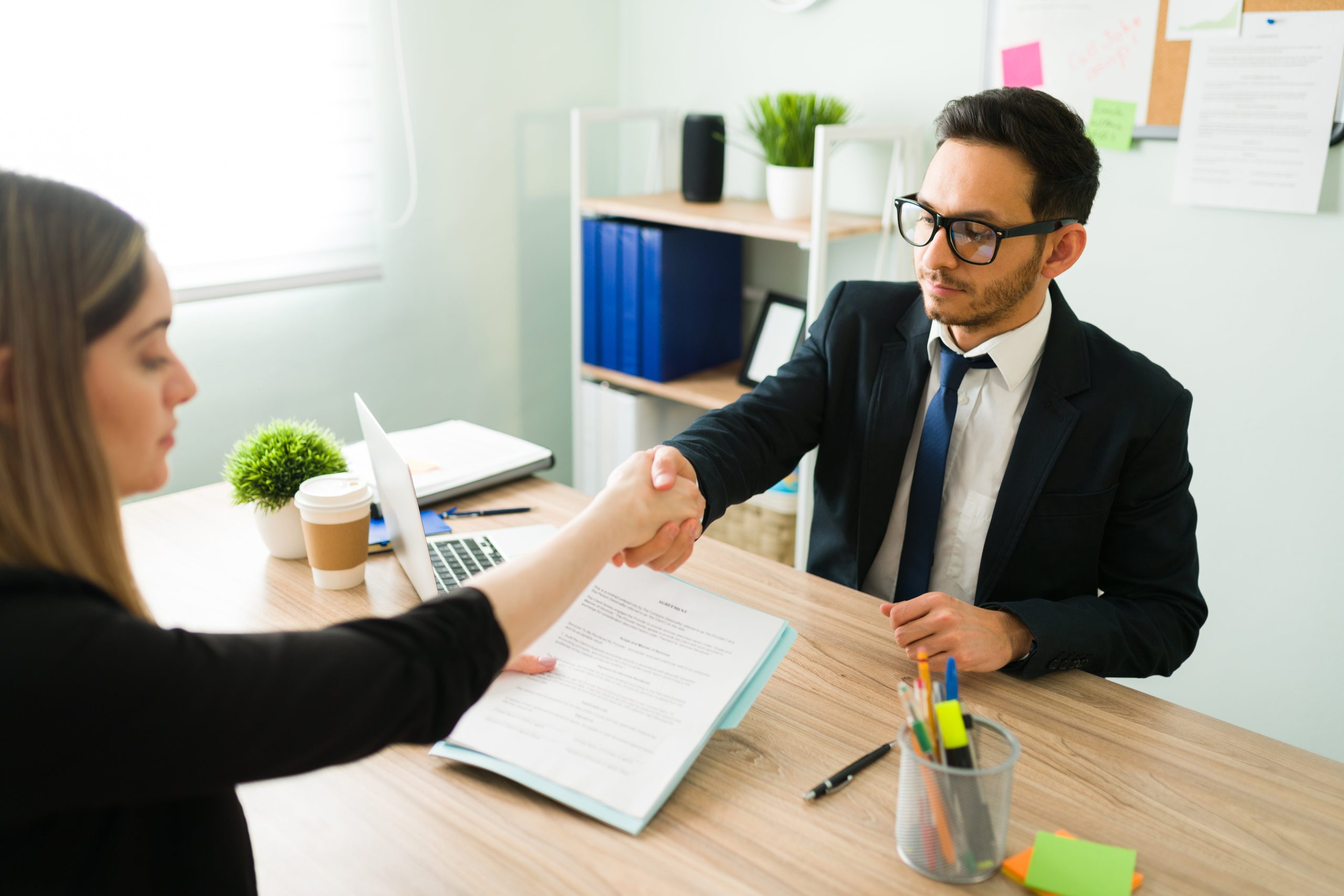 A software engineer applicant shaking hands with an interviewer.