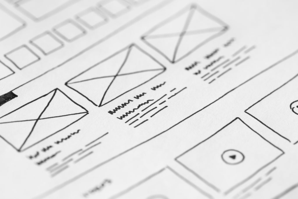 A drawing of a proposed website design, drawn on paper by a UI/UX designer.