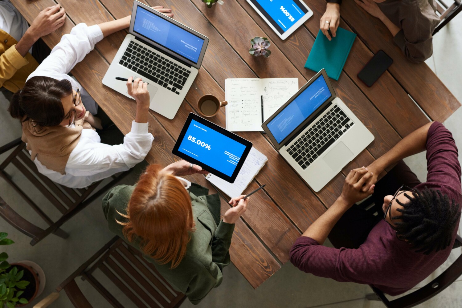 A group of offshore software developers working together and discussing work progress.